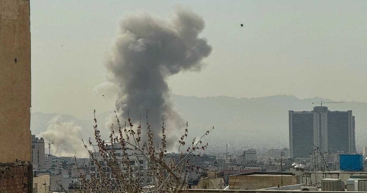 Smoke rising over Tehran skyline following airstrikes on government compound